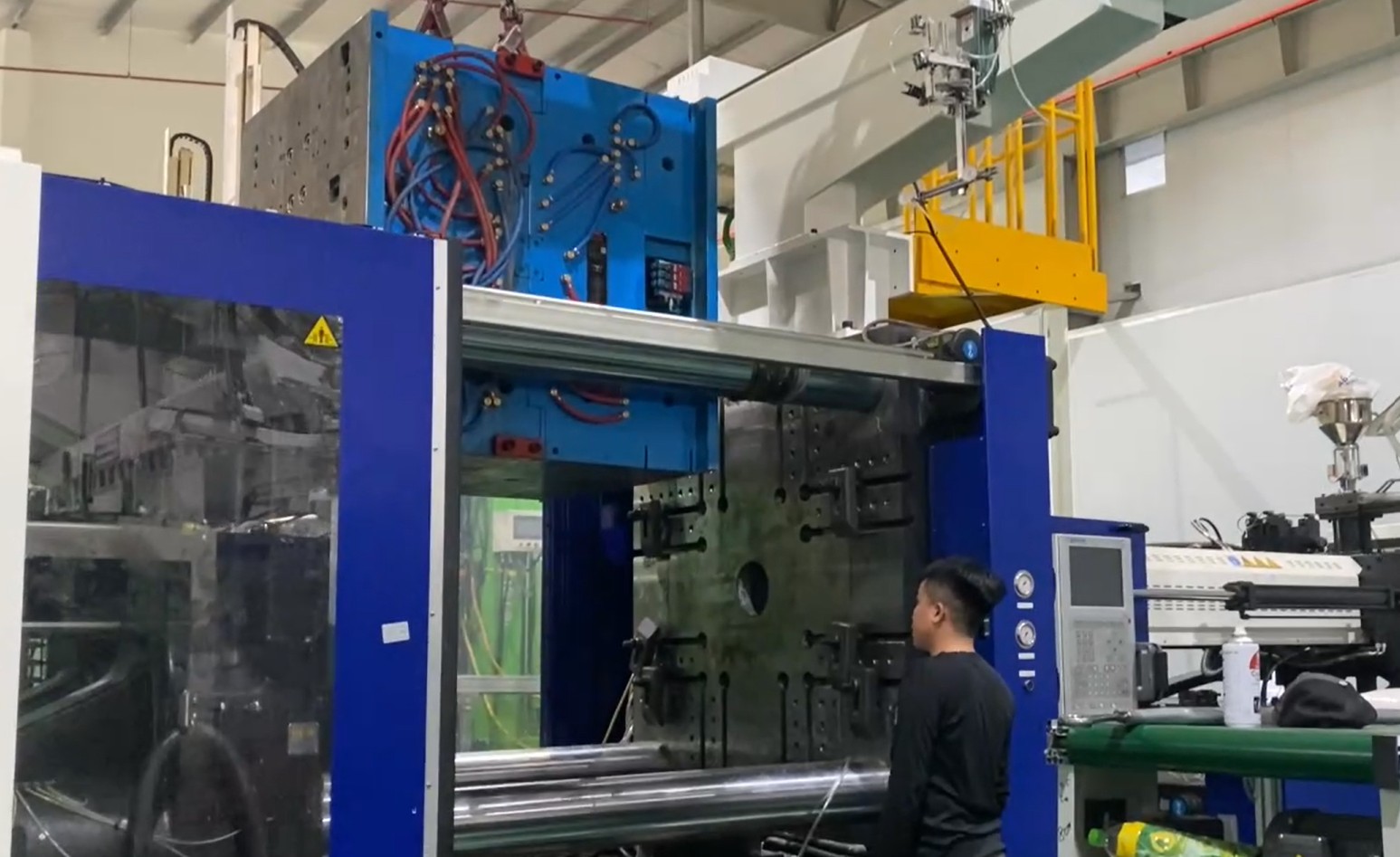 Technician installing mold into injection molding machine.jpg